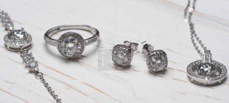 Photo for Beautiful silver set with diamonds on a wooden background - Royalty Free Image