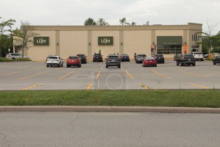 Photo for Lcbo liquor control board of ontario logos side of building and front entrance, parking lot with cars parked, wide shot, building top frame - Royalty Free Image