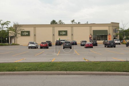 Photo for Lcbo liquor control board of ontario logos side of building and front entrance, parking lot with cars parked, wide shot, building middle frame - Royalty Free Image