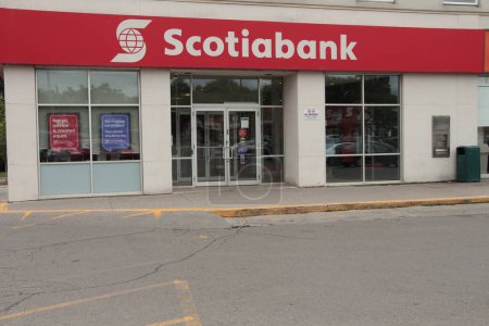 Photo for Scotiabank storefront, caption writing text logo on front entrance of store with windows, white writing on red background - Royalty Free Image