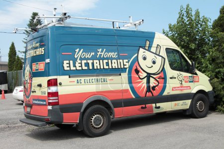 Photo for Your home electricians ac electrical caption writing text printed on the side of a work van, blue white yellow orange - Royalty Free Image