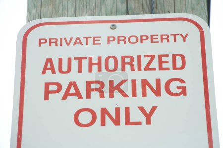 Photo for Private property authorized parking only sign, red writing on white background with sky background - Royalty Free Image