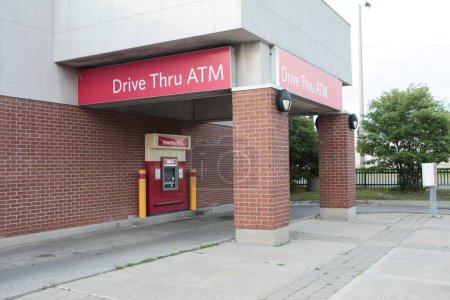 Photo for Drive thru atm writing caption text red white sign bank machine drive thru with bank machine and no cars in it - Royalty Free Image