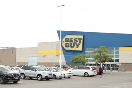 Photo for Best buy technology appliance franchise store with parking lot in front with customer person walking in it, wide shot - Royalty Free Image