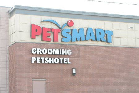 Photo for Petsmart grooming petshotel sign logo with door below on back of store in summer, close up - Royalty Free Image