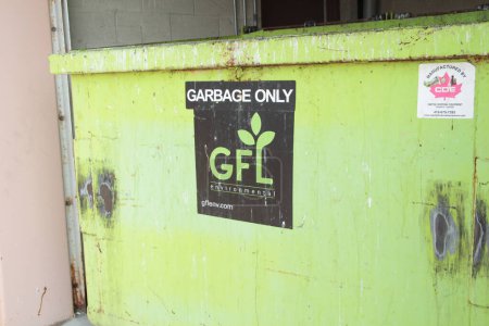 Photo for Gfl green for life environmental garbage only dumpster bin logo sign black white green - Royalty Free Image