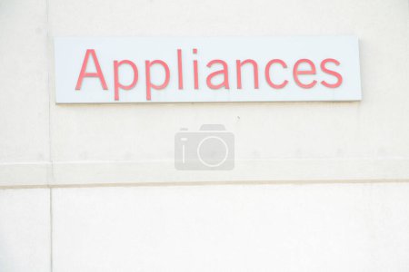 Photo for Appliances word writing caption text sign in red on white rectangle background on beige building wall exterior outside outdoors, top of frame - Royalty Free Image