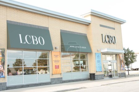 Photo for Lcbo liquor control board of ontario store with logo sign letters writing text on front entrance and wine spirits beer windows with front automatic doors closing - Royalty Free Image