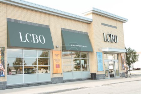 Photo for Lcbo liquor control board of ontario store with logo sign letters writing text on front entrance and wine spirits beer windows with customer entering through front automatic doors - Royalty Free Image