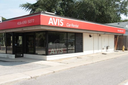 Photo for Avis car rental store business company on bright day with windows - Royalty Free Image