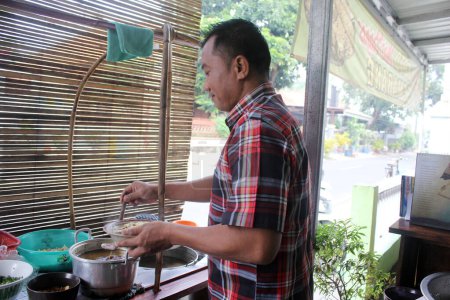 Photo for Pekalongan, Indonesia - June 26, 2023 : Man prepared soto order for consumen. - Royalty Free Image