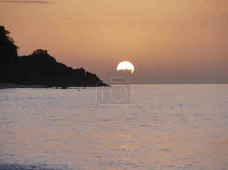 Photo for Sunset over the ocean, partly cloudy, Deshaies, Guadeloupe, french west indies - Royalty Free Image