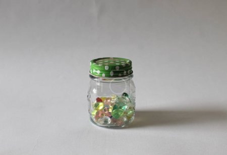 Photo for A picture of colorful beads or precious gem toys in the transparant glass jar - Royalty Free Image