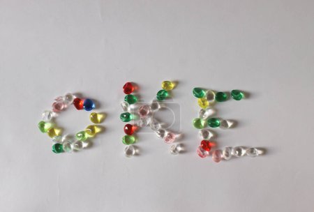 Photo for The letters "OKE" are made of colorful beads on a white background. high quality photo - Royalty Free Image