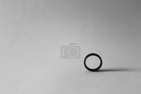 Photo for Black small ring in white background with shadow, simple monochrome photography concept - Royalty Free Image