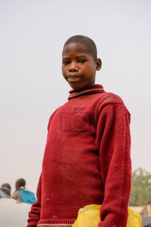 Photo for Abuja, Nigeria - January 6, 2023: Portrait of an African Child Learning in a Rural Community. Smiling African Children Wearing School Uniform. Primary Education in African Villages. - Royalty Free Image