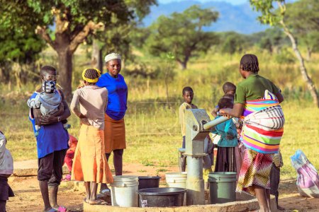 Photo for Talata, Plateau State - April 2, 2023: Indigenous Africans Fetching Water from a Newly Built Indian Hand Pump. Community Members Fetching Water for Domestic Use - Royalty Free Image