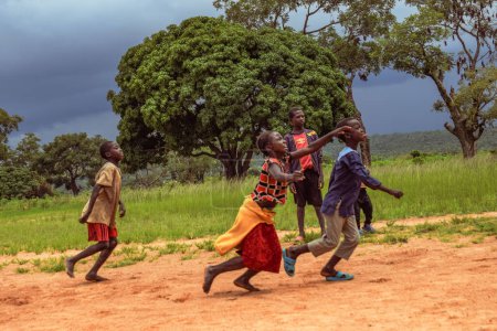 Photo for Lagos, Nigeria - March 02, 2023: African Children Playing Football on a Sandy Field. Sport Activities in Rural Communities in Africa. Street Football among Local African Kids. - Royalty Free Image