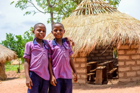 Photo for Abuja, Nigeria - May 6, 2023: Portrait of an African Children Learning in a Rural Community. Smiling African Children Wearing School Uniform in a Classroom. Primary Education in African Villages. - Royalty Free Image