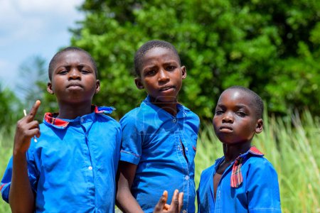 Photo for Abuja, Nigeria - June 12, 2023: Portrait of an African Child Young Students Learning in a Rural Community. Smiling African Children Wearing School Uniform. Education in African. - Royalty Free Image