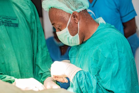 Photo for Abuja Nigeria - February 06, 2021: African Surgeon and Team Members Preparing Patient for a Surgical Procedure - Royalty Free Image