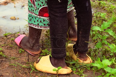 Photo for Nigeria - June 20, 2023: feet of African kids wearing flip-flops footwear, closeup - Royalty Free Image
