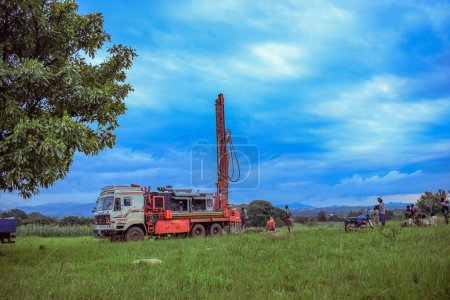 Téléchargez les photos : Jos East, État du Plateau - 12 mai 2021 : Processus de forage d'eau dans une communauté africaine avec des équipements mécanisés. Machine de forage Projet d'eau rurale. - en image libre de droit