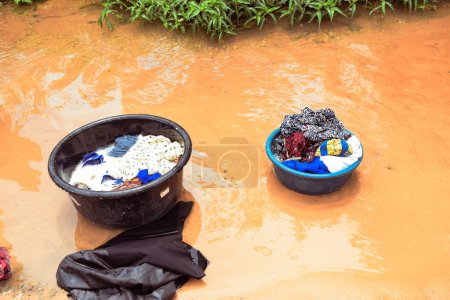 Photo for Delta State, Nigeria - December 9, 2021: washing clothes in river, Nigeria - Royalty Free Image