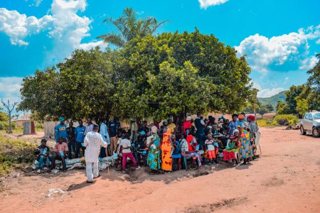 Foto de Aluu, Port Harcourt, Nigeria - 10 de agosto de 2021: Los africanos esperan en una cola para recibir atención médica y atención en una comunidad rural - Imagen libre de derechos