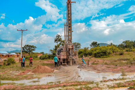 Photo for Jos East, Plateau State - May 12, 2021: Water Drilling Process in an African Community with Mechanized Equipment. Drilling Machine Rural Water Project. - Royalty Free Image