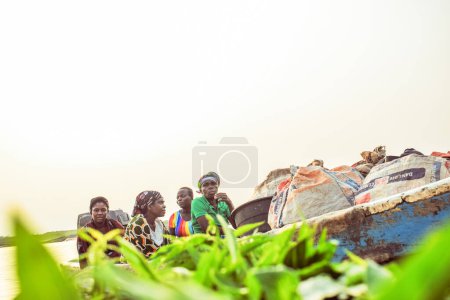 Photo for Delta State, Nigeria - December 9, 2021: Use of Water Transportation in African Communities. Commercial use of African Rivers. Buying and Selling in Rural Environment. Fishing in African Villages. - Royalty Free Image