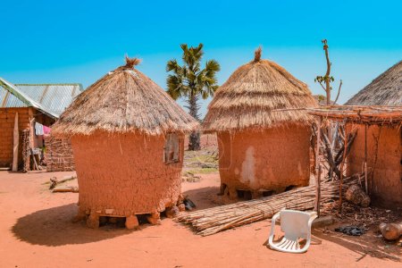 Photo for Opialu, Benue State, Nigeria - March 6, 2021: Typical Housing Structure in an African Village on a Warm Afternoon - Mud House - Royalty Free Image