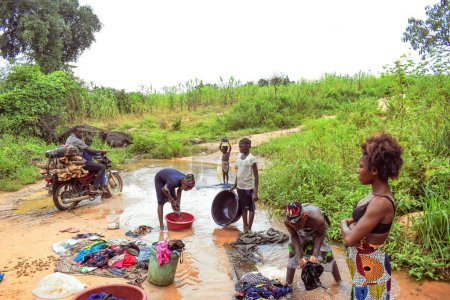Photo for Delta State, Nigeria - December 9, 2021: African women washing clothes in river, Nigeria - Royalty Free Image