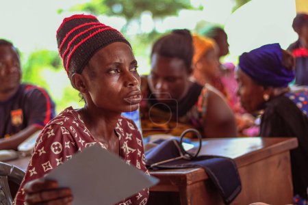 Photo for Abuja, Nigeria - March 06, 2021: African Medical Doctor giving consultation and treatment in a rural clinic. - Royalty Free Image