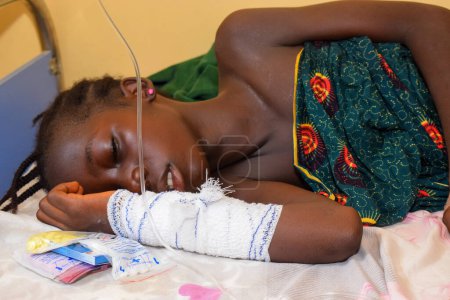 Photo for Ikeja, Lagos State, Nigeria - October 5, 2021: Portrait of an African Child Receiving Medical Care - Royalty Free Image