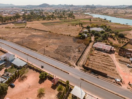 Photo for Establishment Drone Shot of an African Highway in a City Centre. Natural Lake in a Town - Royalty Free Image