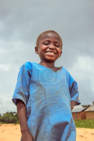 Photo for Plateau State, Nigeria - June 5, 2022: Portrait of an African Child. Random Candid Moments with African Child Outdoor on a Sunny Blue Sky. - Royalty Free Image