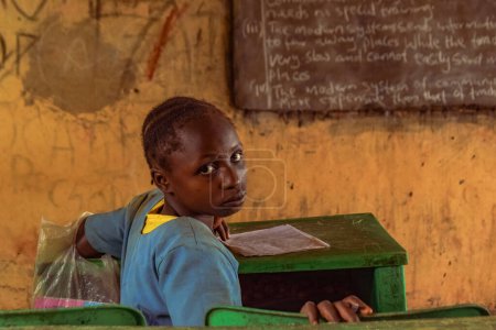 Photo for Abuja, Nigeria - June 6, 2022: Portrait of an African Child Learning in a Rural Community. Smiling African Children Wearing School Uniform in a Classroom. Primary Education in African Villages. - Royalty Free Image