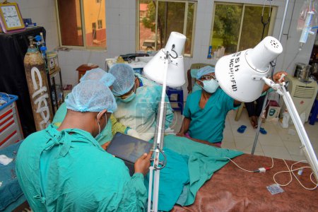 Photo for Abuja, Nigeria - May 06, 2021: African Plastic Surgeon and Team Members Performing a Surgical Procedure in a Medical Theatre - Royalty Free Image