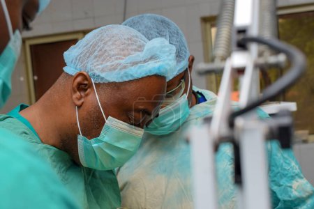 Photo for Abuja, Nigeria - May 06, 2021: African Plastic Surgeon and Team Members Performing a Surgical Procedure in a Medical Theatre - Royalty Free Image
