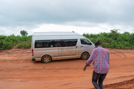 Photo for Loko, Nasarawa, Nigeria - August 06, 2021: Muddy road during rainy season. Vehicles stuck on bad road and causing accident. - Royalty Free Image