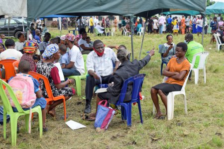 Photo for Aluu, Port Harcourt - August 10, 2021: Africans people waiting for Free Medical Care and Attention in a Rural Community. People Register to Vote in Election. political Campaign Exercise - Royalty Free Image