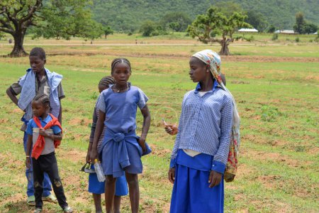 Photo for Abuja, Nigeria - January 6, 2023: Portrait of an African Children Learning in a Rural Community. African Children Wearing School Uniform. Primary Education in African Village - Royalty Free Image