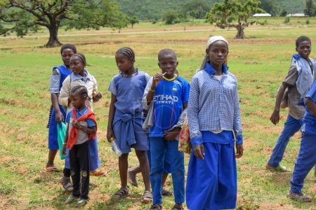 Téléchargez les photos : Abuja, Nigeria - January 6, 2023: Portrait of African Children Learning in a Rural Community. African Children Wearing School Uniform. Primary Education in African Village - en image libre de droit