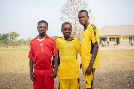 Téléchargez les photos : Opialu, Benue State, Nigeria - mars 6, 2021 : Des adolescents africains vêtus d'un maillot de sport coloré posant à la caméra - en image libre de droit