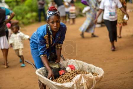 Photo for African woman with peanuts in wheelbarrow - Royalty Free Image