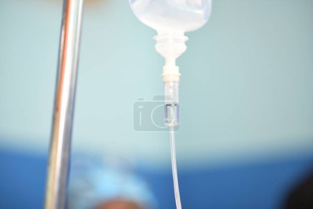 Photo for Abuja, Nigeria - July 7, 2023: Blurred African Surgeon in operating room. Normal Saline infusion prepared for surgery. - Royalty Free Image