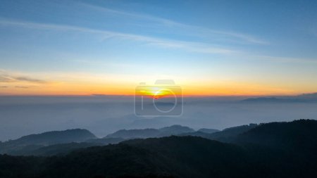 Aerial view of the sky above the hill of Mount Kencana, with beautiful clouds and mist covering the surroundings