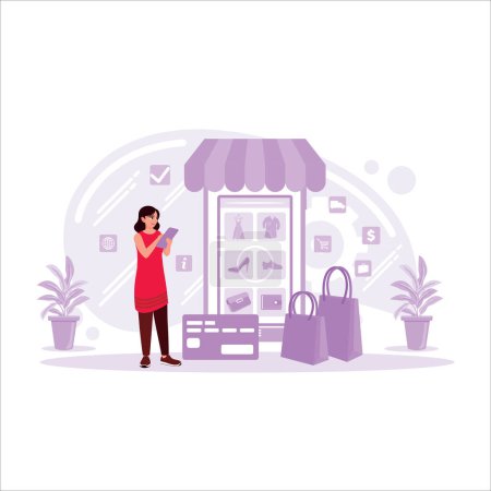 Illustration for A woman is shopping online through a mobile phone with a credit card payment. Online shopping concept. Trend Modern vector flat illustration - Royalty Free Image
