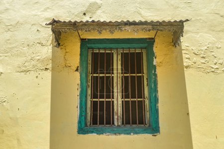 Photo for A green wooden window with iron bars in an old Dutch house in Indonesia - Royalty Free Image